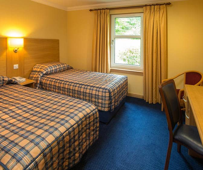 Spacious family room at the Highland Hotel with modern amenities and comfortable furnishings