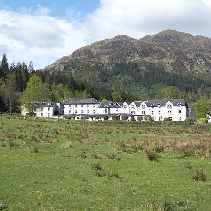 Loch Achray hotel pictured on a sunny day in the height of summer
