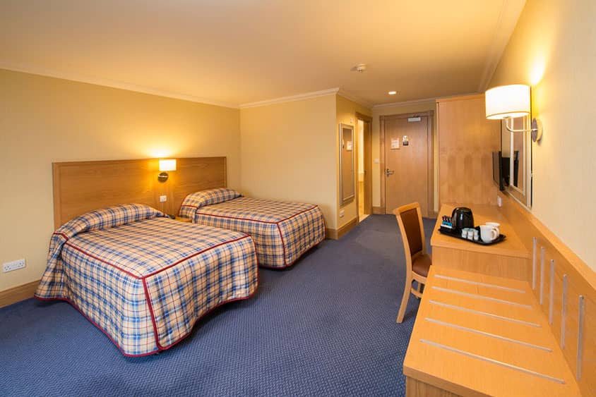 Spacious family room at the Ardgartan Hotel with modern amenities and comfortable furnishings