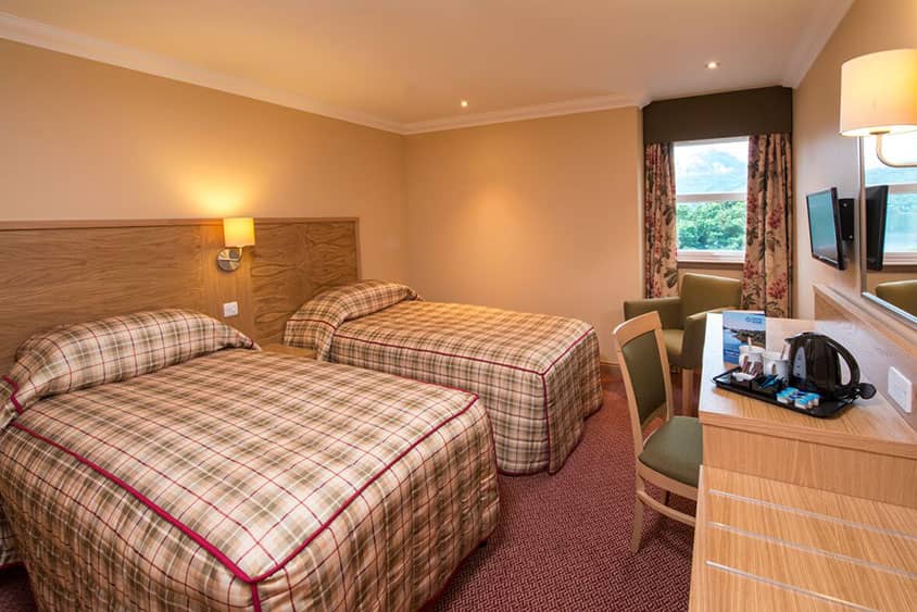 Spacious family room at the Highland Hotel with modern amenities and comfortable furnishings