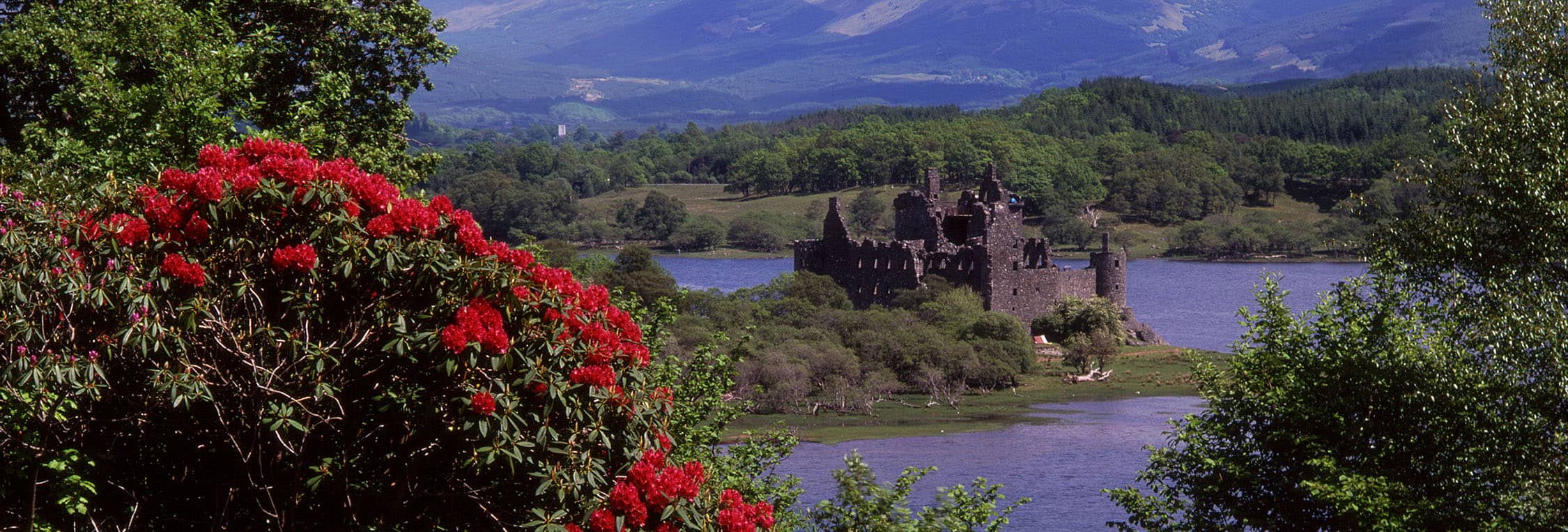 Distance views of the Kilchurn castle on the edge of Loch Awe