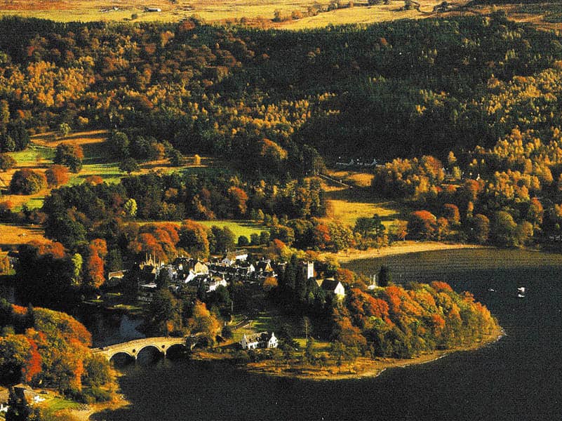 Autumn landscape of the old Tummel area with colorful foliage and historic buildings