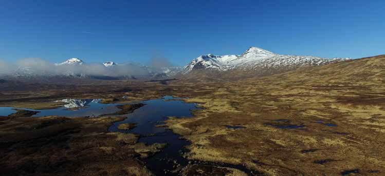 Vast and rugged landscape of Rannoch Moor, with rolling peat bogs, scattered lochs, and distant mountains